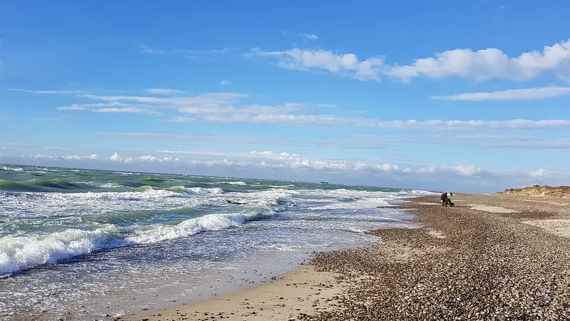 Summer Beach Destinations Without Crowds List: waves on almost empty beach july evening